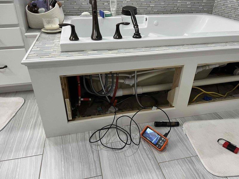 Responded to service call for odor complaint in laundry room sink and drainage issues in master bedroom sink. Removed access panel beneath master bathroom vanity to inspect P-trap assembly and drainage connections. Diagnosed plumbing system using diagnostic equipment to identify source of problems. Addressed drainage concerns in both locations, ensuring proper trap configuration and ventilation to eliminate odors and restore proper function.
