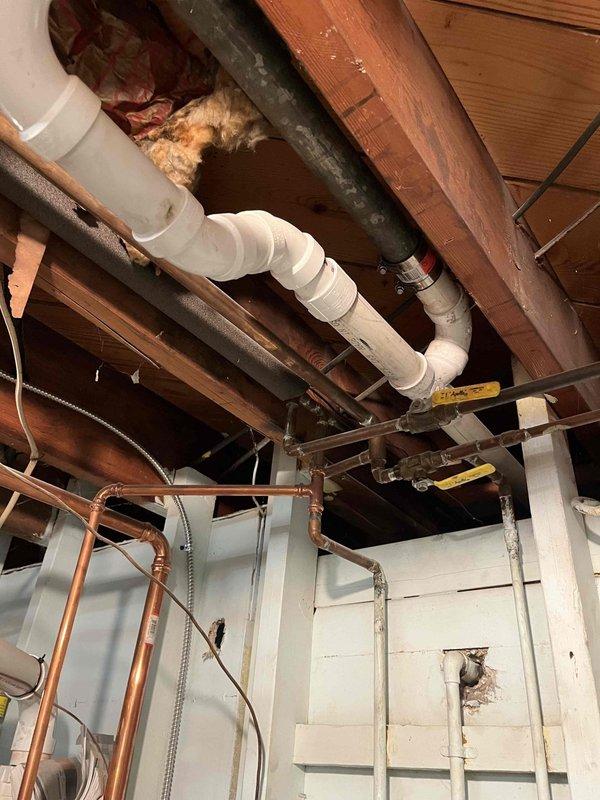 # Plumbing Service Completed

Responded to service call for slow-draining bathroom sink. Upon arrival, conducted assessment of the affected fixture and drainage system. Inspected accessible plumbing infrastructure including PVC drain lines, copper supply lines, and vent piping in the exposed ceiling area above the affected bathroom. Verified proper drainage slope and system configuration using leveling equipment to ensure code compliance. Cleared obstruction causing slow drainage in bathroom sink. Tested fixture operation following service to confirm restored proper flow rate. All drainage systems functioning normally upon completion.