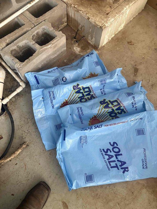 Delivered four bags of solar salt to replenish water softener system that was running low on media. Verified salt product did not contain iron-out additive per customer requirements and loaded salt into brine tank to restore proper system operation.