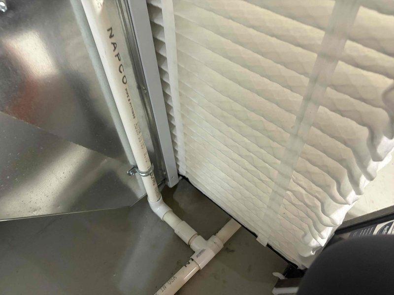 Responded to no cooling call on 2-year-old residential air conditioning system affecting entire home. Upon arrival, performed system diagnostics and inspection of both indoor and outdoor equipment. Inspected air handler in attic space, verifying proper filter installation and airflow. NAFCO pleated filter found properly seated in housing with adequate airflow passage. Examined condensate drainage system including primary drain line, P-trap assembly, and safety switch components. Clear condensate trap confirmed operational and free of blockages, with Rectorseal safety switch properly installed and functioning. All PVC drain piping connections verified secure with no signs of leakage or obstruction. Checked indoor unit operation, electrical connections, and safety controls. System restored to normal cooling operation with whole-house comfort achieved.