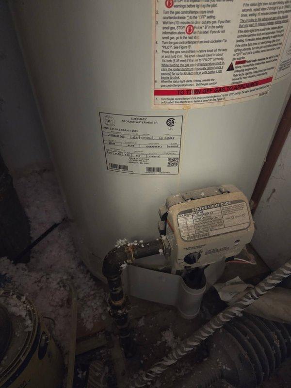 Responded to service call for inoperative gas-fired water heater. Upon arrival, inspected existing unit and confirmed lack of hot water production. Evaluated 40-gallon gas water heater showing significant age-related deterioration, including heavy dust accumulation, water staining on tank exterior, and corrosion visible on copper supply piping connections. Assessed gas control valve, flue venting system, and all associated plumbing connections. Documented existing conditions with photographs showing corroded pipe fittings, mineral deposits, and overall system wear consistent with end-of-service-life failure.
