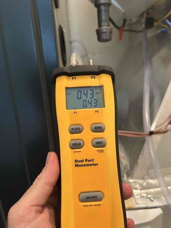 Responded to no cooling complaint on upstairs zone of 1-year-old system. Performed diagnostic testing using digital manometer, measuring static pressures of 0.45 and 0.43 inches water column across the air handler and ductwork system. Inspected recently installed HVAC equipment including air handler, AprilAire indoor air quality system, and associated ductwork connections to identify cause of cooling failure and restore proper system operation.