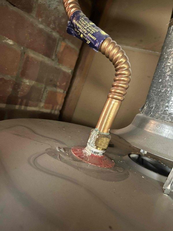 # HVAC Service Completed

Responded to a no cooling call on a residential HVAC system over 10 years old. Upon arrival, performed diagnostic inspection of the outdoor condensing unit and associated components. Examined the gas line connection at the unit, noting the flexible copper corrugated connector with brass fitting and proper thread sealant application. Inspected electrical wiring connections at the concrete pad, identifying multiple supply wires including power conductors. Observed debris accumulation around the base of the unit including leaves and organic material on the concrete pad surface.

Conducted system evaluation to determine cause of cooling failure. Cleaned debris from around unit base and electrical entry points to ensure proper airflow and prevent potential electrical issues. Verified all electrical connections were secure and free from corrosion. Tested system operation and restored cooling functionality to the unit.