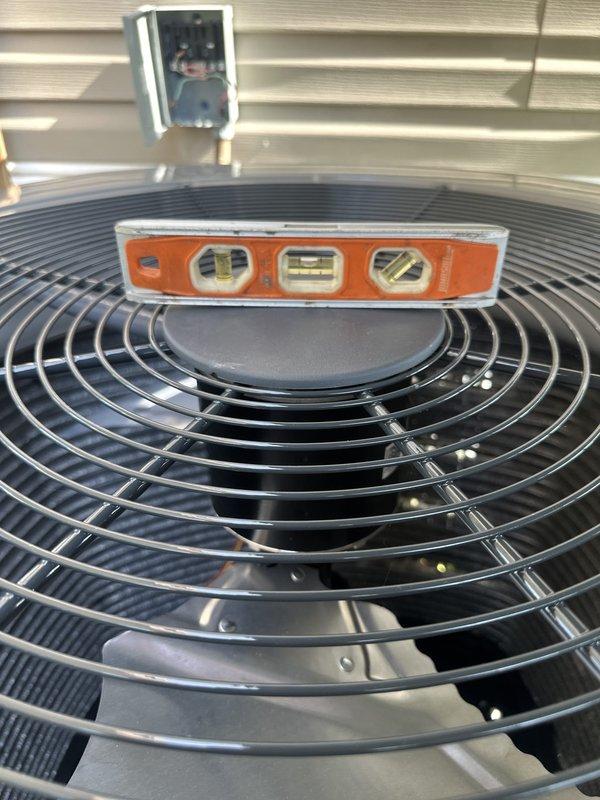 Completed full HVAC system installation including outdoor condensing unit with proper refrigerant line routing and leveling verification. Unit was positioned on gravel pad with adequate clearance for airflow and service access, electrical disconnect box mounted on exterior wall per code requirements, and all connections tested for proper operation prior to system activation.