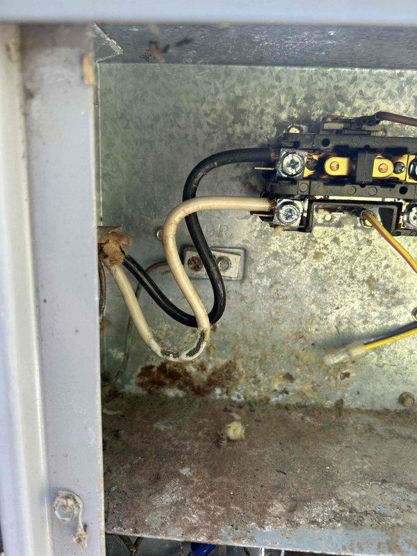 Responded to no-cooling complaint at residential property. Upon arrival, found Carrier thermostat displaying 84°F and calling for cooling. Inspected outdoor disconnect and found electrical connections in deteriorated condition with significant dust accumulation, corrosion, and evidence of moisture intrusion in junction box. Corroded terminal connections and degraded wiring identified as primary cause of system failure. Cleaned and tightened all electrical connections at disconnect, verified proper voltage supply to condensing unit, and confirmed system operation. Unit now cooling properly with thermostat responding to temperature setpoint adjustments.