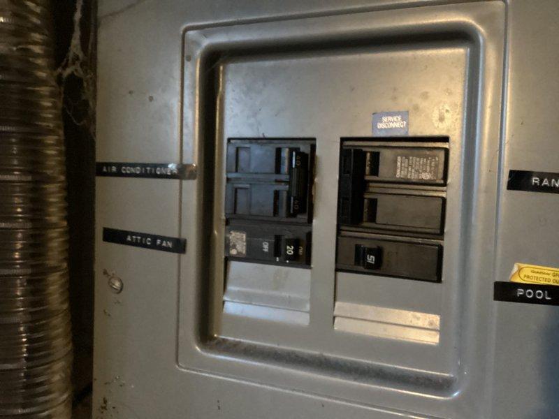 Conducted estimate for complete HVAC system replacement at residential property. Assessed existing exterior condensing unit showing significant age-related deterioration, including rust staining, metal casing discoloration, and weathering from environmental exposure. Evaluated electrical panel configuration and circuit breaker arrangement to determine compatibility requirements for new equipment installation. Documented current system condition and electrical infrastructure to provide comprehensive replacement quotation for upgraded air conditioning system suitable for condominium unit application.