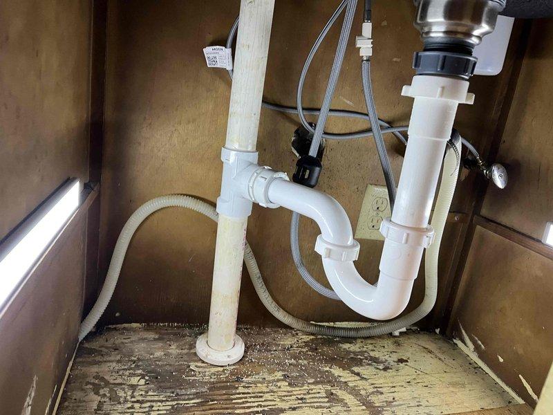 Responded to service call for leaking kitchen sink requiring faucet replacement. Inspected existing plumbing configuration including P-trap assembly, drain lines, and supply connections beneath sink. Removed old faucet assembly and installed new kitchen faucet with integrated pull-out sprayer attachment per customer specifications. Verified all supply line connections were secure, tested for leaks, and confirmed proper drainage and sprayer functionality upon completion.