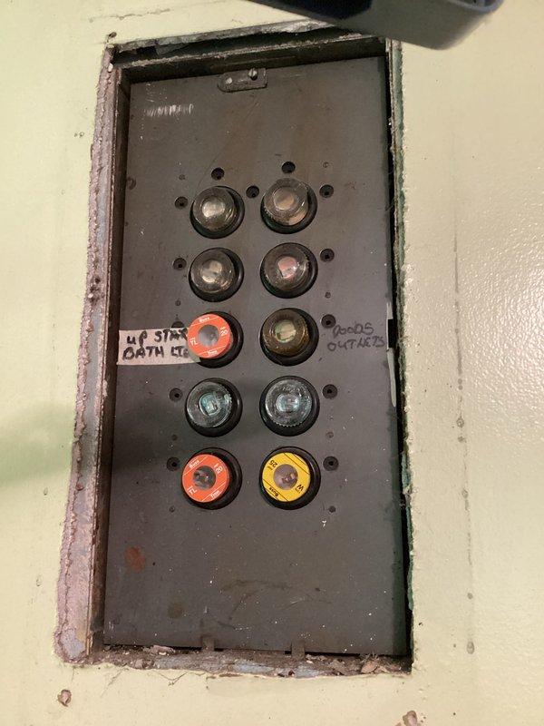 Conducted on-site evaluation for mini split system installation in residential property covering living room and bedroom areas. Assessed existing electrical infrastructure including main panel capacity and circuit availability, documented current heating system consisting of baseboard units, and evaluated installation locations for indoor air handlers and outdoor condensing unit placement. Photographed electrical panel configuration and interior spaces to determine optimal equipment sizing and mounting requirements for proposed ductless heat pump system.
