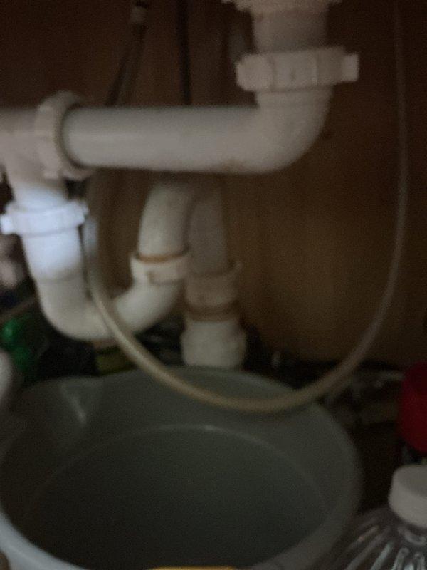 Responded to plumbing membership visit for reported leak under kitchen sink. Inspected under-sink plumbing assembly including P-trap configuration, drain connections, and water supply lines. Documented existing plumbing conditions with photographic evidence for service records.