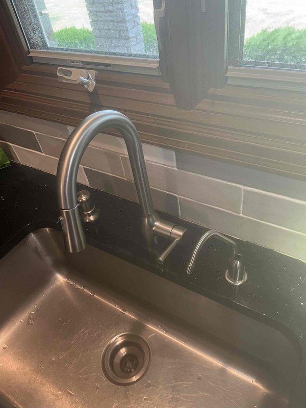 Completed installation of kitchen faucet with pull-down spray head and matching soap dispenser on undermount stainless steel sink. Assessed shower handle assembly for repair feasibility and delivered three bags of solar salt as requested.
