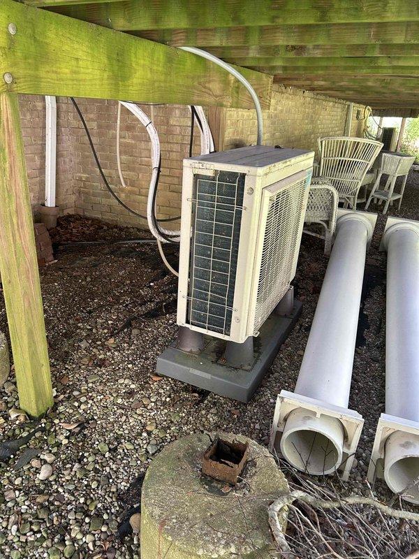 Returned to site with diagnostic equipment to complete PCB board replacement on outdoor condensing unit. Previous appointment had been delayed due to vendor shipping issues with overnight parts delivery. Upon arrival, verified parts availability and completed installation of the printed circuit board. Unit was located beneath raised deck structure on gravel pad, with exterior coil showing heavy debris accumulation and significant soiling that would benefit from future maintenance cleaning to restore proper airflow and efficiency.