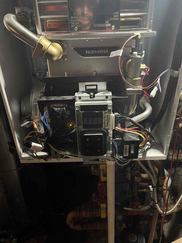 Returned to property to complete previously sold board replacement on Navien heating unit. Removed access panel and replaced failed control board assembly, reconnecting all electrical wiring harnesses and verifying proper connections to digital display panel, transformer, and associated components. Restored unit to operational status and confirmed system functionality upon completion.