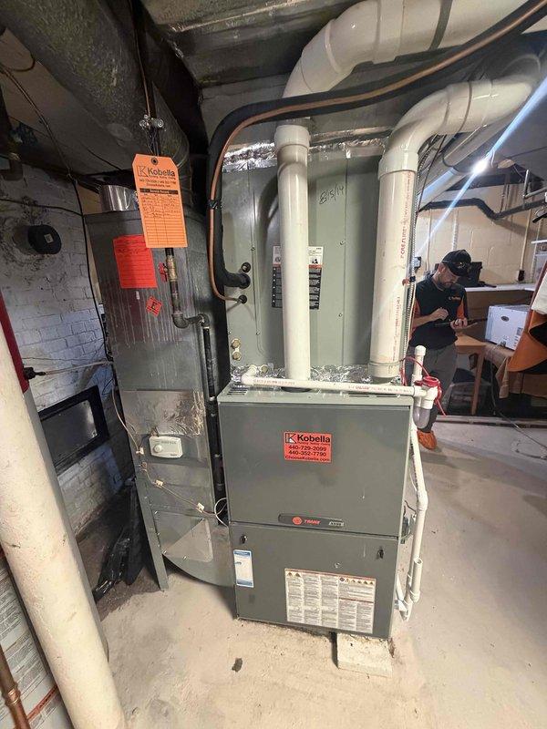 Responded to service call for water discharge from air handler unit. Upon inspection, found condensate drainage issue causing water to pour from the system. Evaluated condensate drain line, drain pan, and associated components on the Trane air handler to identify source of water leak and restored proper drainage function to prevent further water damage.