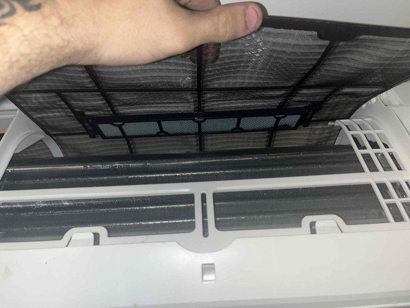 Completed prepaid maintenance visit on wall-mounted air handler following recent installation. Inspected evaporator coil assembly and found heavily clogged air filter with significant dust and debris accumulation. Removed and cleaned filter, verified evaporator coils were in good condition with minimal buildup, and confirmed proper operation of unit.