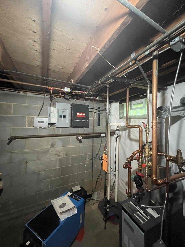 Conducted site assessment for first-time central air conditioning installation in residential property with no existing cooling system. Evaluated basement mechanical room infrastructure, including electrical panel capacity, available space for equipment placement, and existing plumbing/heating system configuration. Documented utility room layout with exposed ceiling joists and assessed attic installation feasibility as alternative equipment location per previous contractor recommendation.