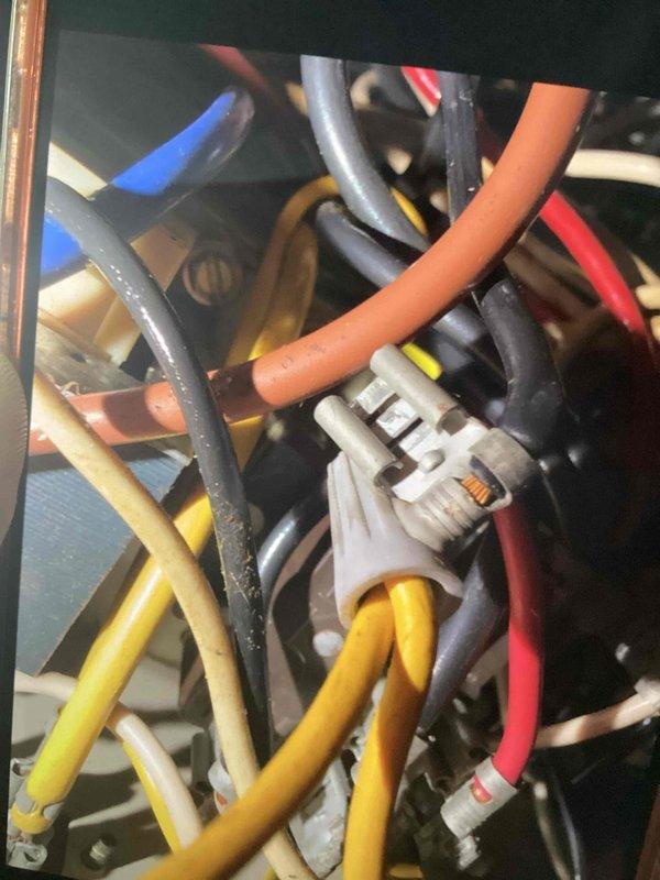 Responded to service call for air conditioning system fan operation issue. Upon inspection, accessed electrical control panel and examined existing wiring connections. Customer requested fan functionality only; heating system work was declined per customer preference. Documented electrical wiring configuration and connection points within the control panel for service records.
