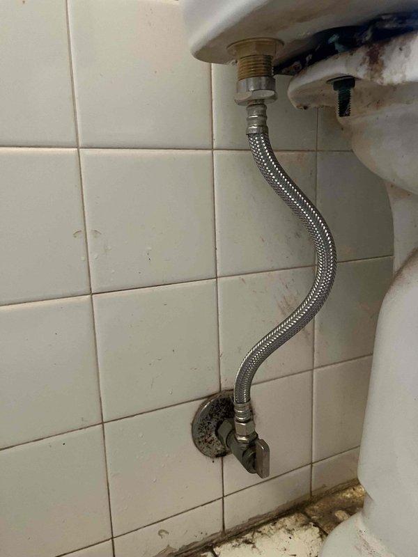 Responded to service call for malfunctioning toilet fill valve in a 10-year-old Kohler two-piece elongated toilet (model K-3551-0 or K-3487), chair height, 1.28 GPF with 10-inch deep tank. Upon inspection, confirmed the existing slider/piston style fill valve was not operating properly. Removed the defective fill valve assembly and installed a new replacement fill valve unit to restore proper tank filling function. Tested the toilet operation to ensure proper water level, fill cycle, and shut-off performance. System now functioning correctly with no leaks detected at supply line connections.
