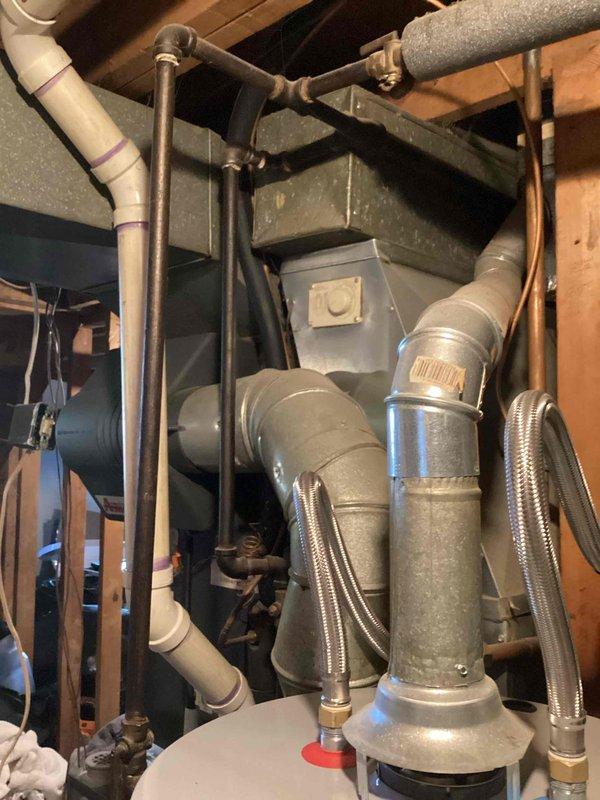 Completed HVAC system assessment for non-operational gas furnace and failed air conditioning system in residential basement utility area. Documented existing ductwork configuration, plumbing connections, and mechanical equipment layout including water heater integration points to prepare comprehensive replacement estimate for new heating and cooling system installation.