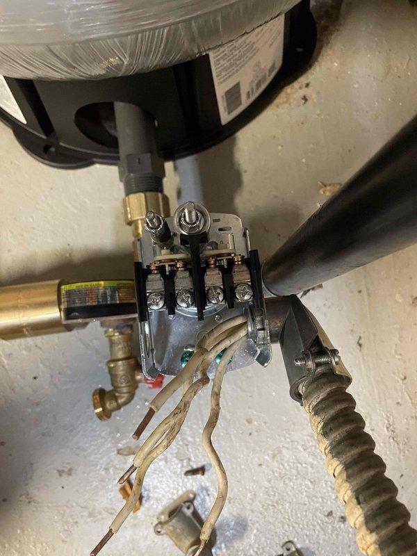 Responded to water leak on well line servicing residential property. Upon inspection, located leak in water supply system and performed necessary repairs to stop water loss. Inspected pressure regulation system including Boshart pressure gauge and brass manifold assembly with red-handled isolation valve. Verified proper operation of pressure regulator and associated copper piping connections. Checked water heater installation and gas valve assembly for any related issues or water damage. Completed repairs to well line, restored water service, and confirmed system pressure within normal operating parameters. All connections tested and verified leak-free upon completion.