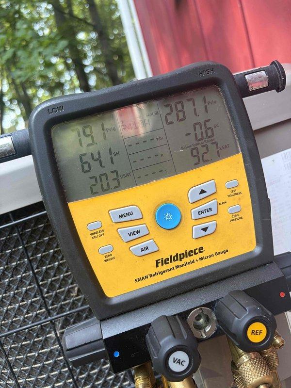 # HVAC Service Report: No Cool Condition

Responded to service call for non-operational barn unit over 10 years old. Upon arrival, performed comprehensive diagnostic evaluation of the Luxaire HVAC system. Utilized Fieldpiece SMAN refrigerant manifold and micron gauge to assess system pressures and refrigerant levels. Gauge readings indicated abnormal pressure differentials with high-side reading of 64.1 PSI and low-side reading of 19.1 PSI, along with superheat of 20.3°F and subcooling of 29.7°F, suggesting potential refrigerant charge issues or system restrictions.

Conducted thorough inspection of indoor furnace unit and associated ductwork in basement installation. Verified all electrical connections, safety controls, and operational components. System showed signs of age-appropriate wear consistent with 10+ year operation. Evaluated airflow through metallic duct system and confirmed proper structural mounting and support.

Performed vacuum and pressure testing procedures to identif