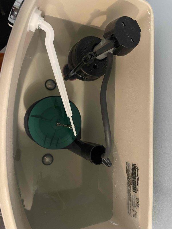 Responded to complaint of multiple toilets intermittently running and filling in 10-year-old residence. Inspected American Standard toilets approximately 1.5 years old to diagnose issue. Removed tank lids and examined internal flush mechanisms, including fill valves, flappers, flush valve assemblies, and float mechanisms. Found standard components functioning within normal parameters with no visible signs of wear, damage, or malfunction. Verified proper water levels and refill tube connections. No evidence of venting issues or active leaks observed during inspection. Photographed tank interiors for documentation purposes.