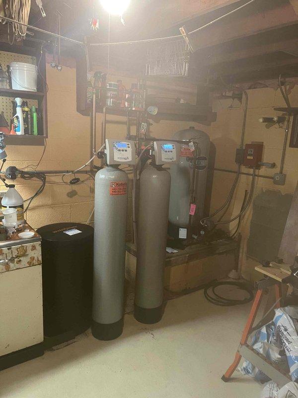 Responded to service call regarding malfunctioning water treatment system. Upon inspection, found water softener with critically low salt level and dirty condition affecting system performance. Added one bag of salt as temporary measure to maintain basic operation until comprehensive diagnostic appointment could be scheduled. Documented existing three-tank water filtration system configuration and reviewed lab analysis report showing elevated iron and silica levels requiring specialized treatment approach for permanent resolution.
