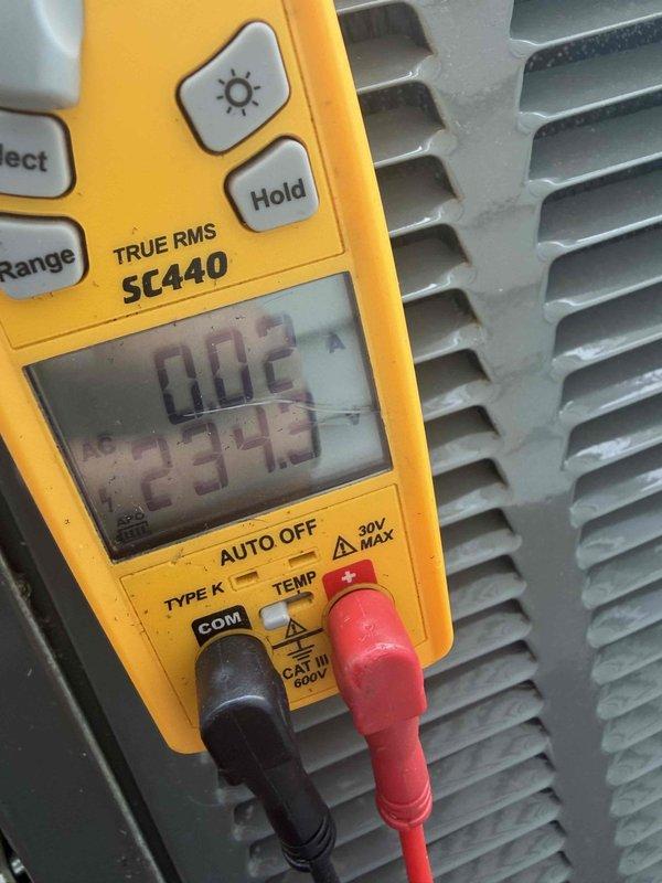 Completed cooling maintenance for club member. Performed system diagnostics and electrical testing using digital multimeter, recording voltage readings of 234.7V AC and 299.9V to verify proper electrical supply and component operation. Inspected condenser unit and documented equipment condition with photos for service records.