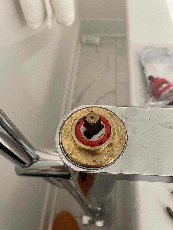 Completed installation of new Kohler tub faucet cartridge replacement. The repair involved removing the old worn cartridge assembly showing signs of age and mineral buildup, then installing the factory replacement cartridge with new seals and gaskets to restore proper hot/cold water mixing and flow control to the bathtub faucet.