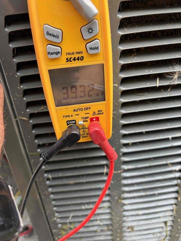 Completed club membership renewal service and performed routine HVAC air handler maintenance inspection. Conducted operational diagnostics using digital multimeter, recording temperature readings of 38.3°C and voltage measurements of 490.7V to verify system performance parameters. Documented equipment condition with photographic evidence showing coil surfaces with moderate dust and debris accumulation between fins, consistent with normal outdoor unit exposure.