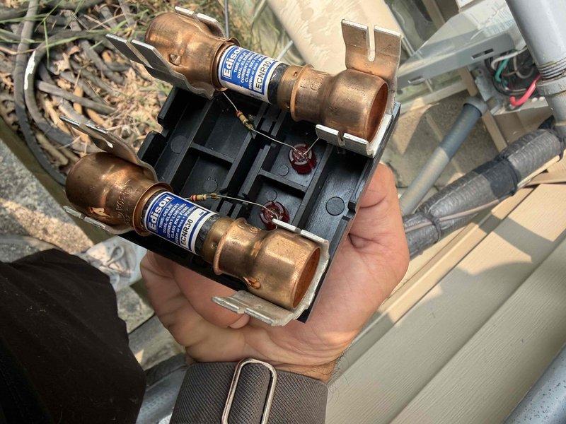 Completed cooling maintenance for club member. Performed electrical diagnostics using digital multimeter to verify proper voltage and amperage readings at the outdoor condensing unit. Inspected and tested dual-element fuse assembly, confirming both fuses were intact and providing adequate circuit protection. All electrical components operating within normal parameters.