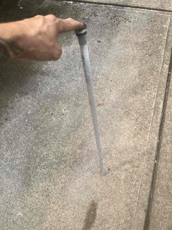 Responded to customer complaint of rotten egg odor in domestic water supply. Inspected water heater and confirmed presence of aluminum anode rod, which had not resolved the sulfur smell issue commonly associated with bacterial reaction in the tank. Evaluated system in conjunction with geothermal heating/cooling setup. Documented existing water heater configuration and plumbing connections for potential water treatment system installation or anode rod replacement to address ongoing odor concerns.