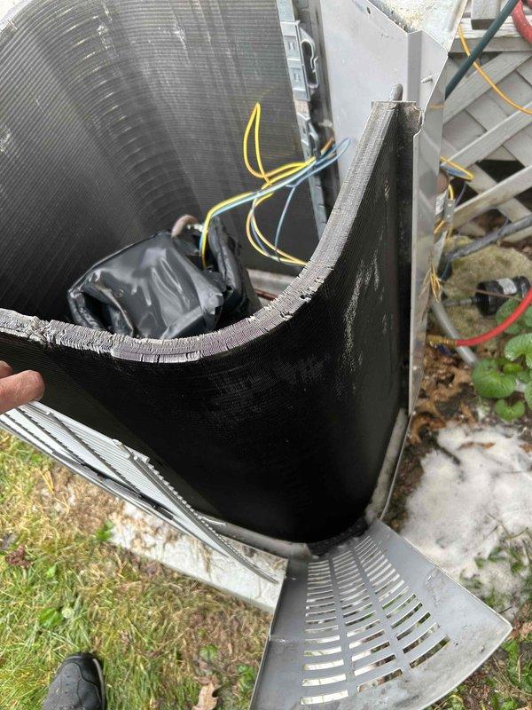 # HVAC Service Completion

Responded to no cooling complaint on aging residential air conditioning system. Upon arrival, performed visual inspection of outdoor condenser unit which showed significant dirt accumulation and external soiling on cabinet panels. Removed top access panel and side service panel to access internal components for diagnostic evaluation.

Conducted thorough assessment of condenser coil, refrigerant lines, and electrical connections. Condenser coil displayed heavy dirt and debris buildup between fins, restricting airflow and reducing heat transfer efficiency. Inspected refrigerant line insulation on both liquid and suction lines - found insulation intact with proper securing. Verified electrical disconnect box operational and properly mounted.

Unit exhibited typical wear patterns consistent with 10+ years of outdoor exposure including weathered cabinet finish and accumulated environmental contamination. Internal components accessible for service with standard ref