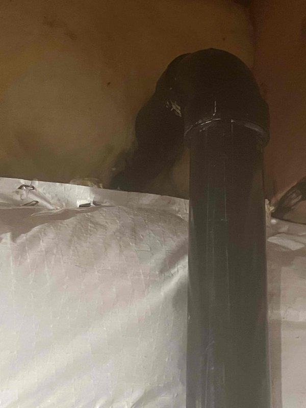 Responded to service call for suspected sump pump discharge pipe leak. Upon inspection, accessed the discharge line routing through exterior deck structure and attic space. Confirmed active leak at pipe penetration point where discharge line exits through building envelope. Removed deck boards to expose compromised pipe connection and traced discharge line through attic to identify full extent of water intrusion. Documented deteriorated pipe seal and improper weatherproofing at roof/ceiling penetration point causing moisture infiltration. Recommended replacement of damaged discharge pipe section, proper sealing of deck penetration, and installation of appropriate flashing and weatherproofing at attic penetration to prevent future leaks and water damage.