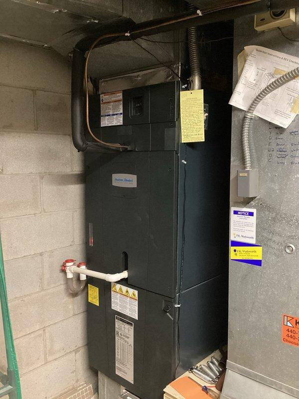 Conducted on-site evaluation for complete HVAC system replacement in residential property. Assessed existing air handler unit installed in basement utility area with black metal cabinet configuration, noting current refrigerant line routing, flexible ductwork connections, and PVC condensate drain system. Documented existing equipment specifications and manufacturer information for replacement sizing calculations.

Evaluated ductwork infrastructure including horizontal cylindrical metal duct runs through unfinished framing areas. Photographed installation conditions and equipment placement to develop accurate replacement proposal. Confirmed service scheduling parameters and established arrival window of 11:00 AM to 1:00 PM to accommodate customer availability requirements. Provided detailed replacement quote covering new equipment specifications and installation scope.