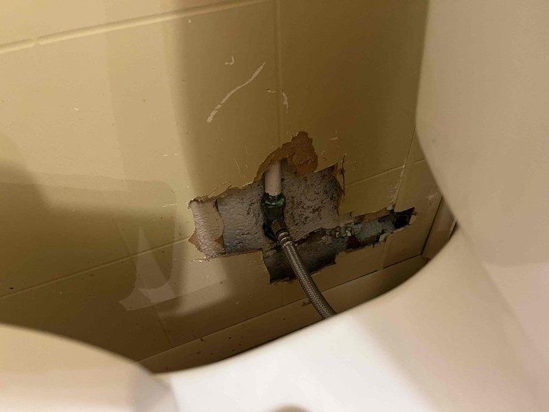 Completed comprehensive plumbing maintenance inspection at club facility. Inspected kitchen sink P-trap assembly and drainage system, confirming proper installation of PVC trap configuration and supply line connections. Documented wall damage near toilet fixture where flexible supply line penetrates compromised drywall, noting deteriorated material and structural concerns requiring repair to prevent further water damage and maintain code compliance.