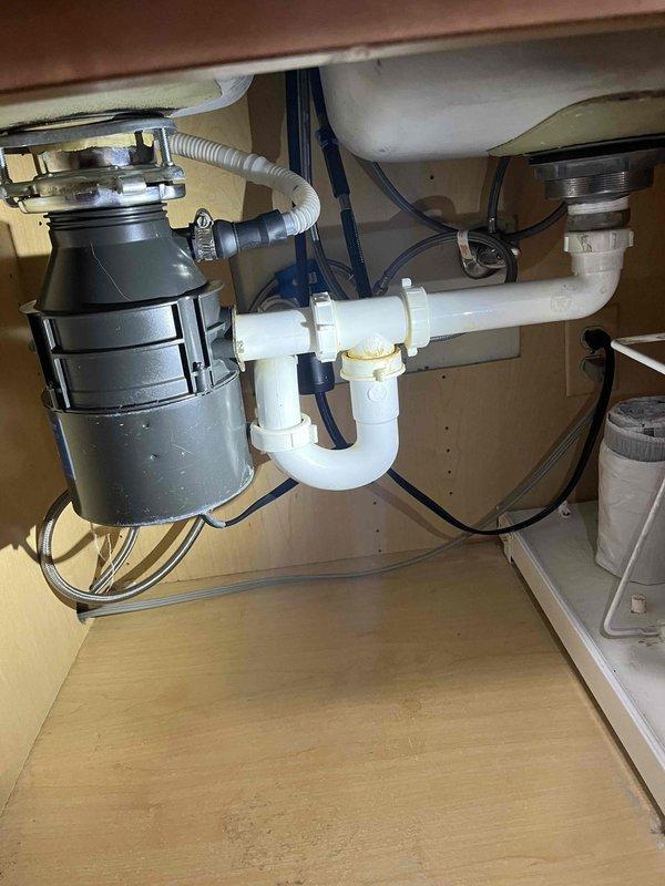 Responded to service call for two kitchen sinks not draining properly with garbage disposal involvement. Performed main drain cleanout to resolve drainage obstruction affecting the double-bowl sink system. Cleared blockage from main drain line, restoring proper flow through P-trap configuration and garbage disposal discharge. Verified proper drainage function of both sink basins and garbage disposal unit upon completion. Provided financing information to customer for service payment arrangement.
