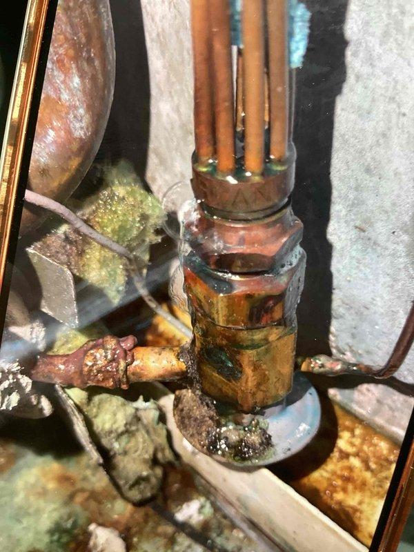 Responded to no cooling complaint on R22 system with complete refrigerant loss due to failed thermal expansion valve joint. Upon inspection, found severe corrosion and deterioration at TXV connection point with visible refrigerant leak at brass fitting junction. Replaced corroded thermal expansion valve assembly, pressure tested system for leaks, evacuated to proper vacuum levels, and recharged system with R22 refrigerant to manufacturer specifications. Verified proper system operation, confirmed adequate cooling performance, and documented existing corrosion on copper piping throughout unit. System restored to full operational capacity.
