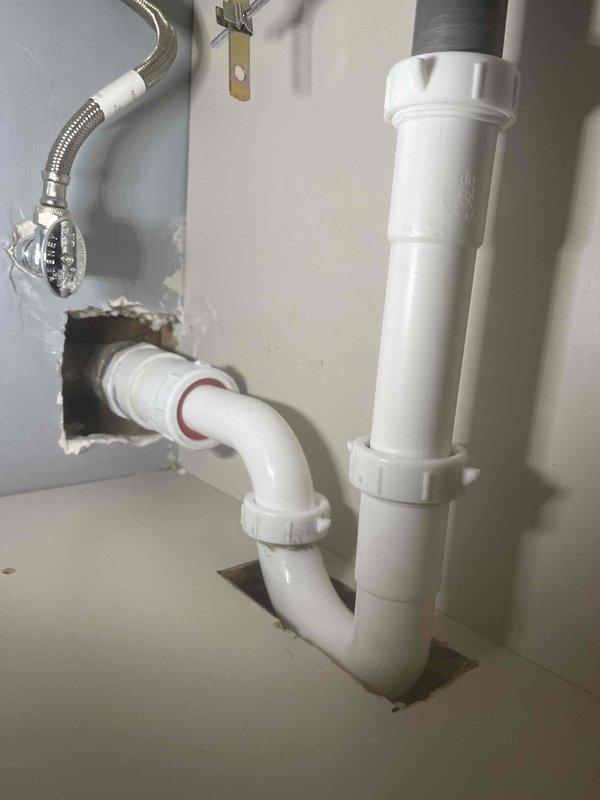 Completed return visit for previously sold plumbing repair work. Installed new copper supply line assembly with brass compression fittings and red-handled ball valves in attic space, ensuring proper connections to existing HVAC ductwork and structural framing. Additionally, replaced under-sink drainage system with new white PVC P-trap assembly and tailpiece, along with braided stainless steel flexible supply line installation, verifying all connections are secure and leak-free.