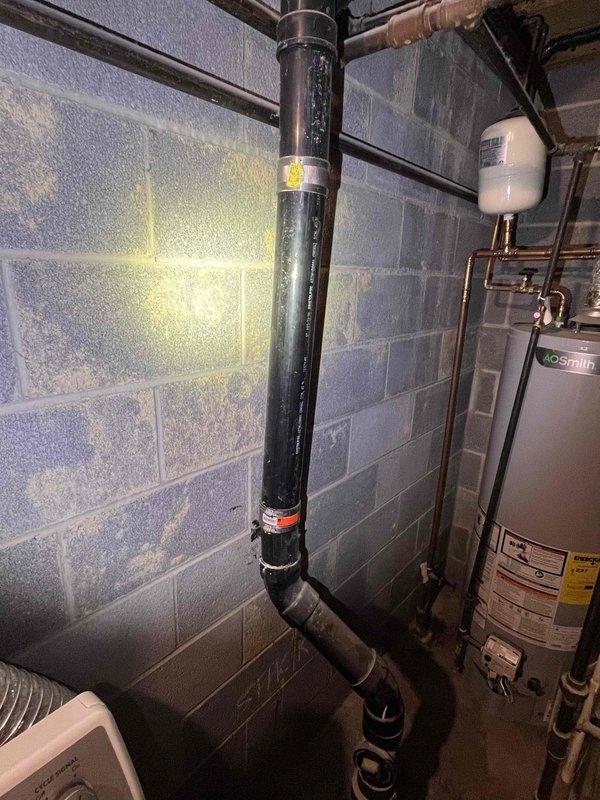 Responded to service call for leaking faucet in basement utility area of 40-year-old residential property. Upon inspection, assessed plumbing infrastructure including water heater connections, copper piping network, and associated fixtures in mechanical room with cinder block construction. Repaired basement faucet to eliminate leak, ensuring proper function and water flow control. Verified all connections were secure and tested system operation to confirm no additional leaks were present in the immediate plumbing area.