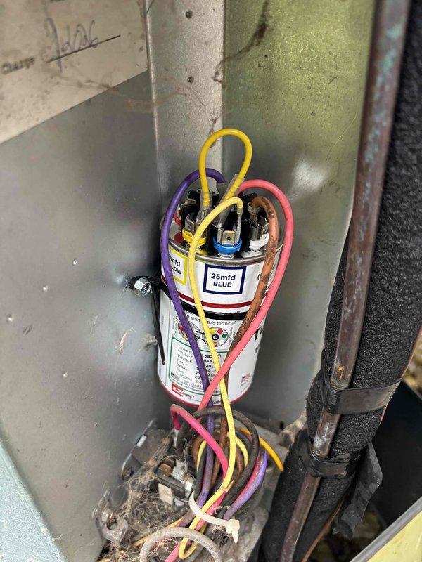 Completed routine cooling maintenance member visit on HVAC system. Inspected and photographed capacitor assembly showing 25mfd dual run capacitor with proper electrical connections and terminal wiring intact. All components operating within normal parameters with no immediate service needs identified during this preventive maintenance inspection.