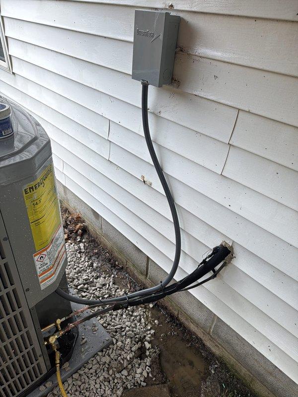 Completed full HVAC system installation including outdoor condensing unit with proper electrical disconnect and refrigerant line connections. System was pressure tested and charged to manufacturer specifications, with all readings verified within normal operating parameters. Unit was mounted on gravel pad with appropriate clearances and all electrical conduit properly secured to building exterior per code requirements.