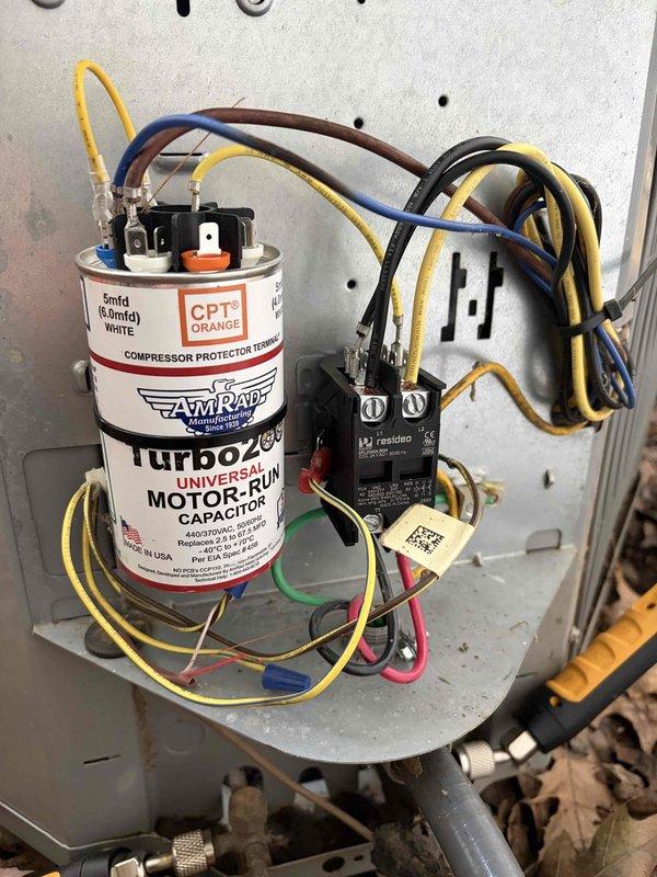 Responded to no cooling complaint with condenser unit not operating. Upon inspection, found failed run capacitor preventing compressor from starting. Removed defective AMRAD Turbo 200 capacitor and installed new universal motor-run capacitor with proper microfarad rating. Verified all electrical connections at contactor and compressor protector terminal, tested system operation, and confirmed unit cooling properly with condenser running at normal amperage.