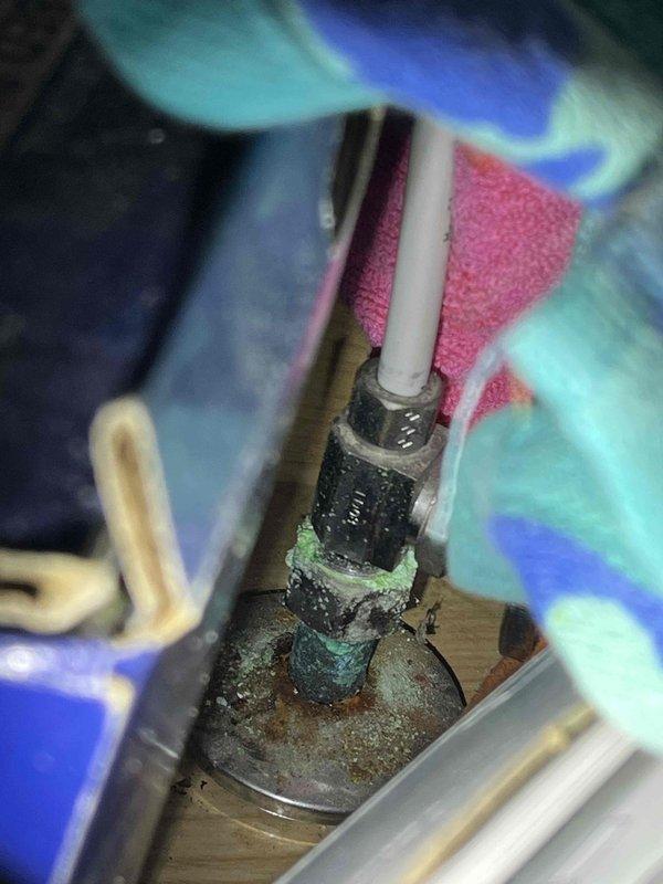 Completed comprehensive plumbing inspection addressing two primary concerns. Adjusted water pressure at kitchen sink to restore proper flow rate. Repaired leaking hot water handle in master bathroom, which involved servicing corroded valve assembly showing significant oxidation and mineral deposits on copper connections and fittings beneath the sink.