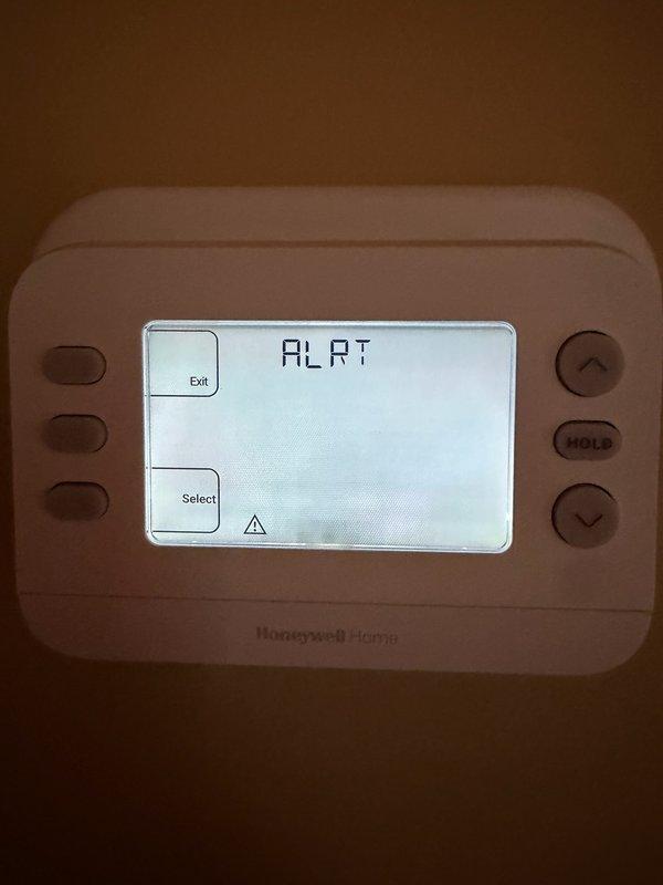 Responded to callback for system not cooling properly. Upon arrival, found Honeywell Home thermostat displaying alert status with warning indicator. Current indoor temperature reading 73°F with setpoint at 68°F, system calling for cooling but failing to achieve desired temperature. Investigated thermostat alert condition and addressed communication or sensor issue preventing proper system operation. Cleared alert status, verified thermostat functionality, and confirmed proper system response to cooling demand. Documented conditions with photos for service records.