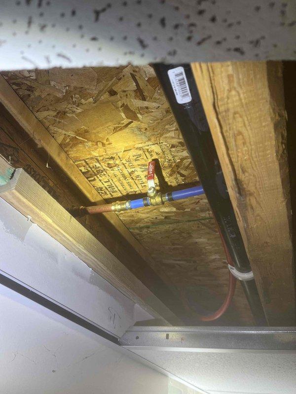 Responded to complaint of inconsistent water pressure after water department had already investigated. Inspected pressure reducing valve (PRV) and associated plumbing system to diagnose malfunction. Evaluated expansion tank installation, shut-off valves, and piping connections in basement utility area. Confirmed PRV failure was causing erratic water pressure throughout residence. Documented existing system configuration including copper piping, brass fittings, and expansion tank setup for service records.