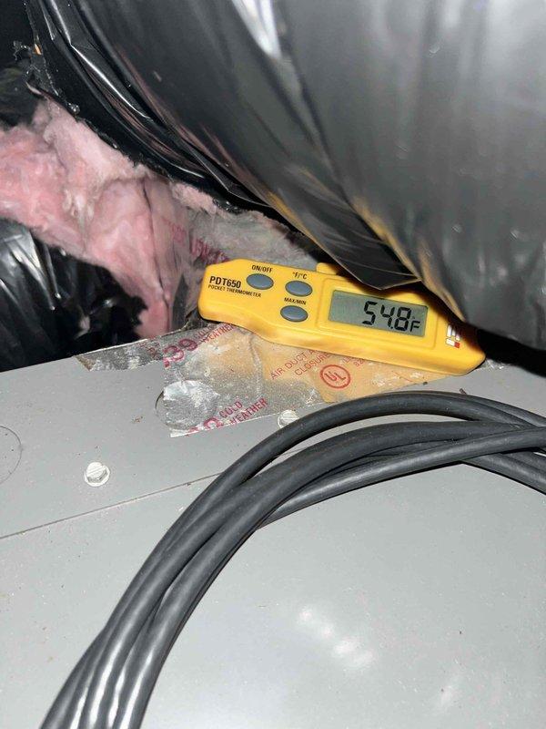 Performed comprehensive air conditioning tune-up and system evaluation. Conducted temperature diagnostics using digital thermometer, recording supply air temperature of 54.8°F, and verified electrical parameters with multimeter showing proper voltage readings of 240V. System operating within normal specifications with all components functioning correctly.