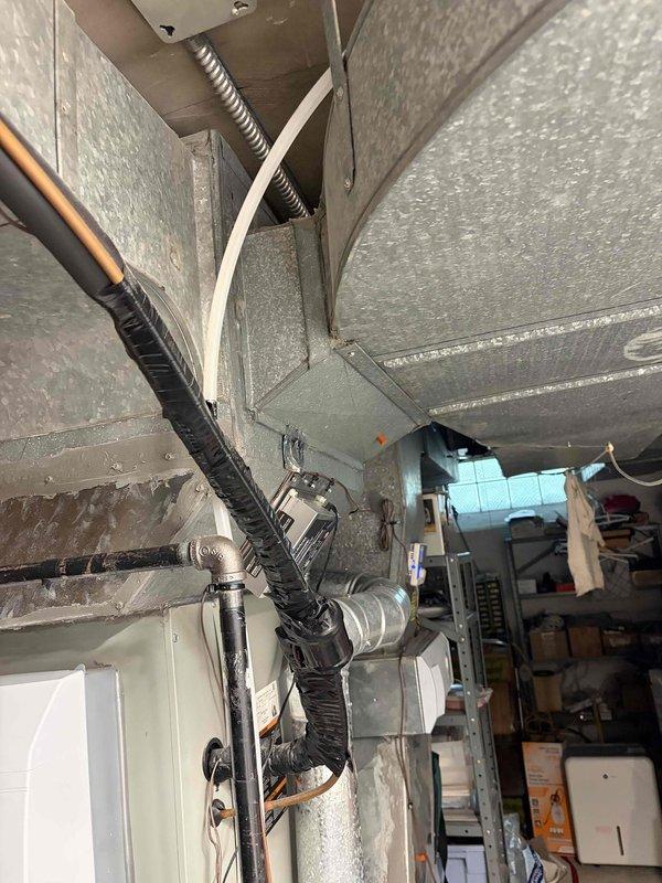 Returned to property to complete previously sold condensate drain line replacement. Removed old deteriorated condensate tubing from HVAC system and installed new PVC condensate drain piping with proper pitch and secure mounting brackets along wall. Ensured proper drainage pathway from air handler unit, verified all connections were sealed and secure, and confirmed condensate flow was functioning correctly. System tested and operational upon completion.
