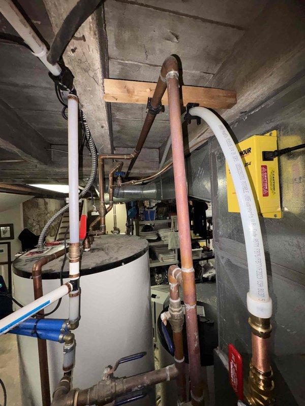 Completed return visit to install water heater expansion tank at standard height specification as originally sold. Verified proper copper pipe connections, ball valve installation with Legend valve assembly, and appropriate mounting height per standard requirements rather than universal height configuration. All plumbing connections secured with brass compression fittings and system tested for proper operation.