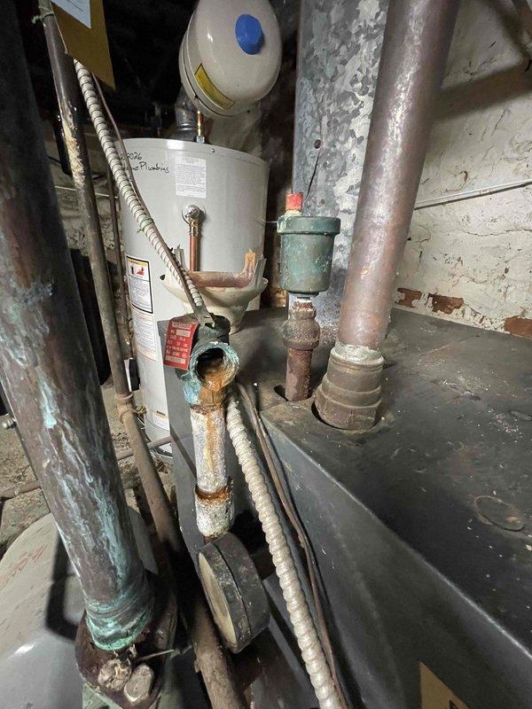 Returned to property to complete plumbing repairs on water heater system that were previously sold. Upon inspection, addressed severely corroded copper piping showing extensive rust deterioration and aging components throughout the mechanical system. Performed necessary repairs to ensure proper function and safety of the water heating equipment and associated plumbing connections.