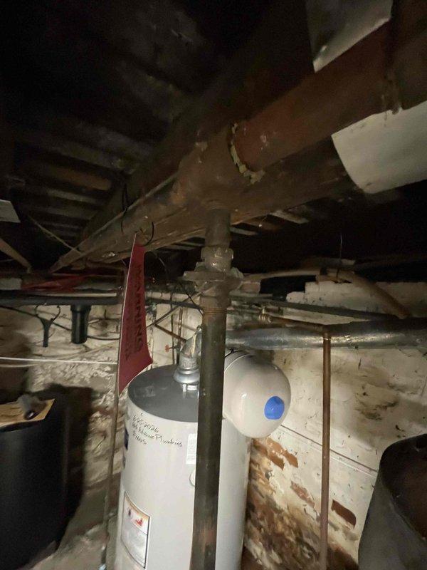 Returned to property to complete plumbing repairs on water heater system that were previously sold. Upon inspection, addressed severely corroded copper piping showing extensive rust deterioration and aging components throughout the mechanical system. Performed necessary repairs to ensure proper function and safety of the water heating equipment and associated plumbing connections.